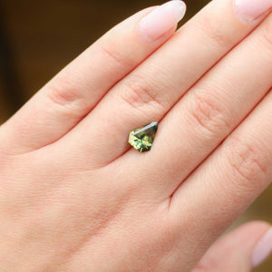 Shield shaped green sapphire on hand