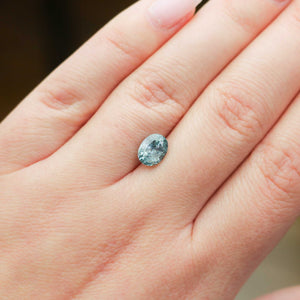 Oval shaped blue sapphire on hand