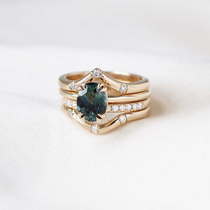 Teal sapphire solitaire ring with gold stacking rings