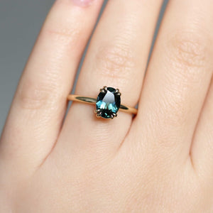 Teal sapphire solitaire ring on hand