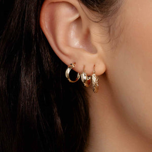 Diamond Cut Gold Hoop Earrings worn on ear