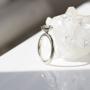 Oval grey diamond ring side view in sunlight