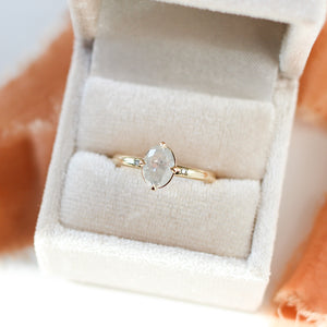 Oval icy diamond ring in ring box