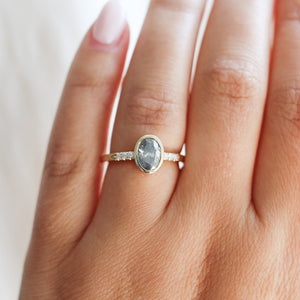 Oval salt and pepper diamond ring on hand