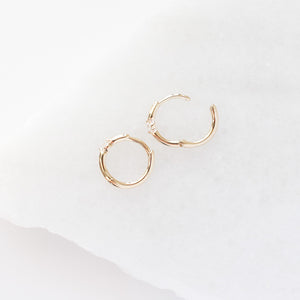Floating Diamond Hoops open on marble profile view
