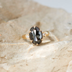 Oval Black Diamond Ring on stone close up