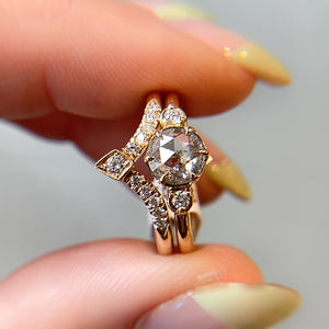Round rose cut diamond ring paired with crown diamond stacking band in hand 