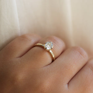 Oval Brilliant cut diamond ring in yellow gold on hand side view