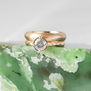 Textured Edge Gold Band stacked with round diamond ring on green marble