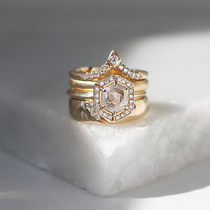 Shooting Star Diamond Ring stacked with large diamond ring and crown diamond band on marble 