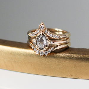 Pear diamond ring paired with 2 diamond gold stacking bands on gold base detail quarter view