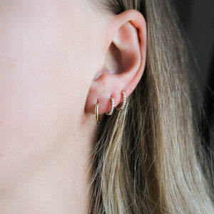 Smooth Hoops in Yellow Gold paired with 2 diamond gold hoops worn on ear