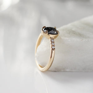 Rose cut oval diamond ring in yellow gold on marble side view