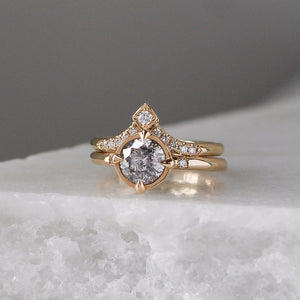 V Shaped Diamond Point Band stacked with round diamond ring on marble