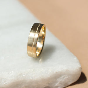 Path Gold Band profile view on marble