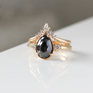 Golden Crown Pear and Round Diamond Ring stacked with black diamond ring quarter view