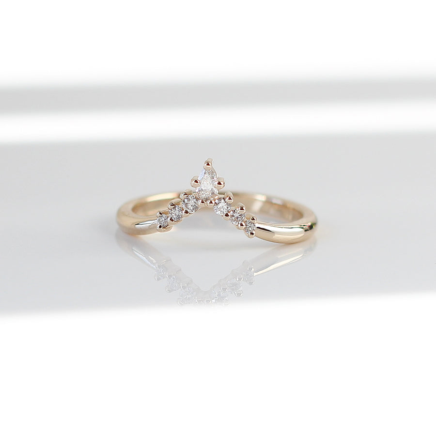 golden crown ring made with pear shaped and round diamonds