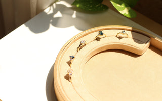 gold engagement rings in a tray in the sun 