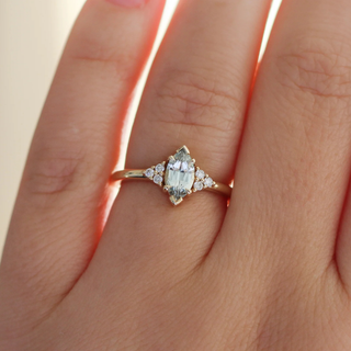 Marquise light green sapphire ring in yellow gold on hand 