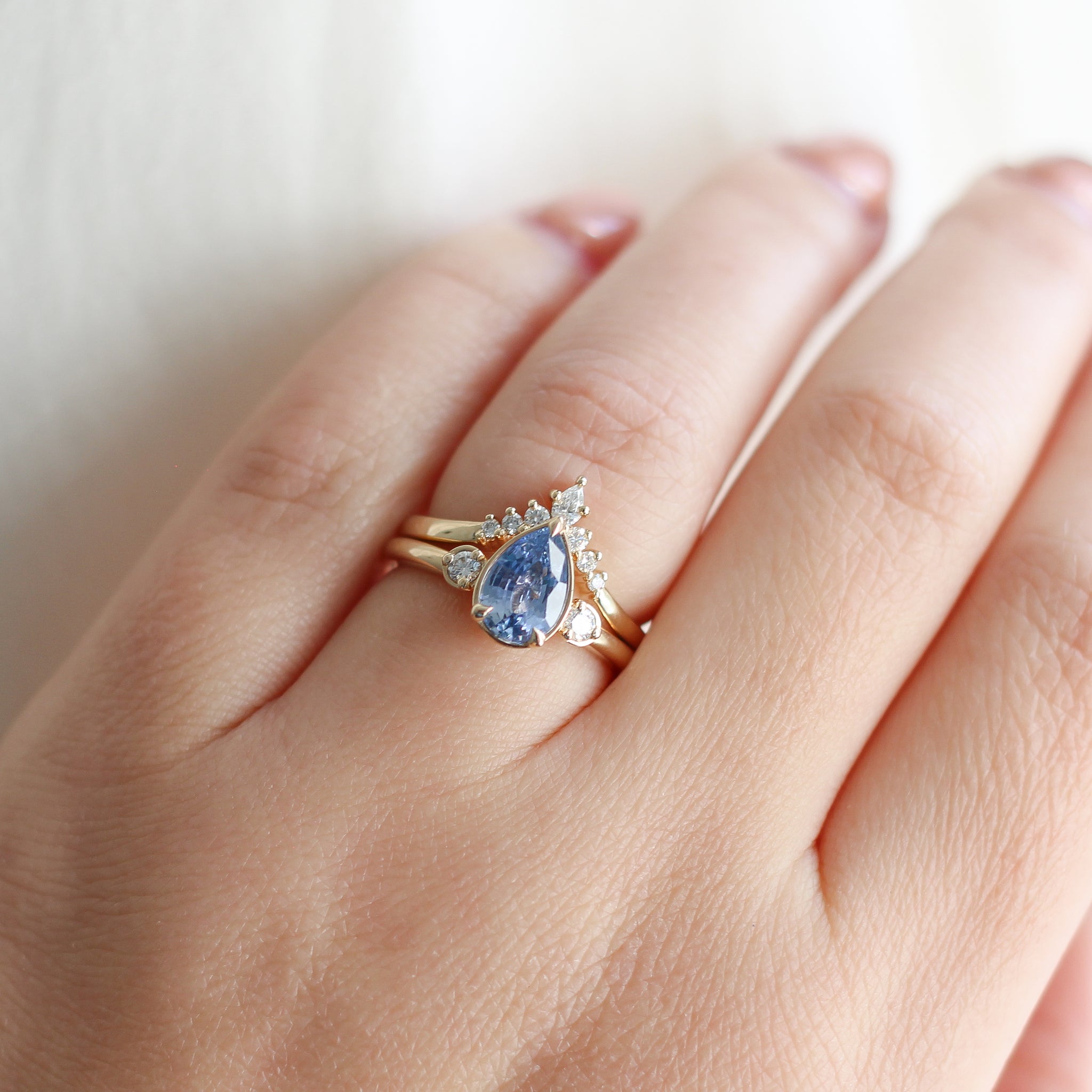 pear blue sapphire and diamond ring in yellow gold