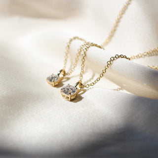 Two Round Lab Diamond Necklaces in yellow gold, larger one in focus