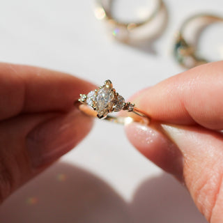 Folia Marquise Cut Champagne Diamond Ring being held in sunlight detailed front view