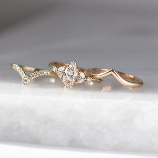 Folia Marquise Cut Champagne Diamond Ring paired with diamond gold band and wave gold band on marble front view