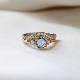 Round Blue Sapphire Ring stacked with diamond gold band on fabric 