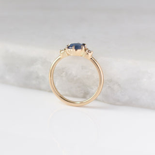 Round Blue Sapphire Ring profile view on marble