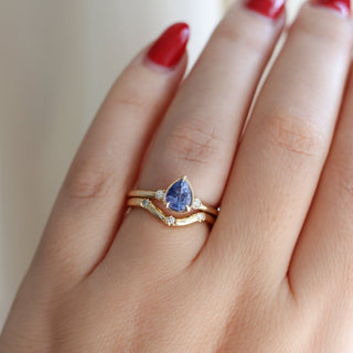Pear Cut Purple Sapphire ring paired with three point wave diamond band worn on hand