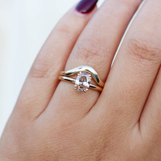 Oval Cut Diamond Ring with wave gold band worn on hand