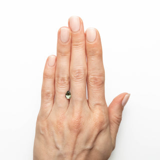 Green pear cut sapphire on hand