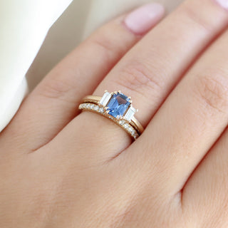  Emerald Cut Blue Sapphire Ring paired with diamond gold band beign worn on hand
