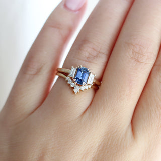  Emerald Cut Blue Sapphire Ring paired with crown diamond gold and being worn on hand