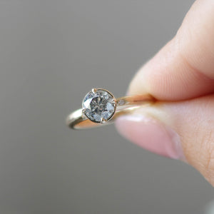 Round salt and pepper diamond ring in hand