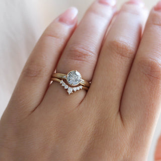 Round salt and pepper diamond ring with curved diamond band on hand