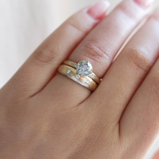 Round salt and pepper diamond ring with wedding band on hand