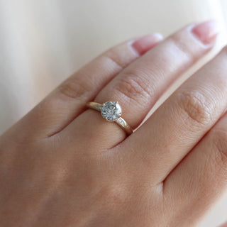 Round salt and pepper diamond ring on hand