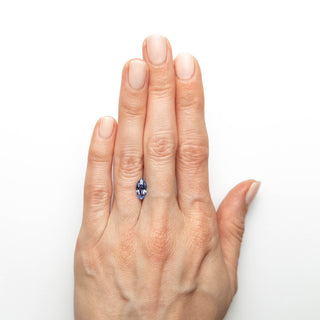 Blue antique cut marquise sapphire on hand