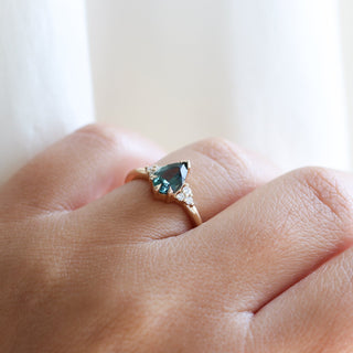 Pear Teal Green Sapphire Ring worn on hand in sunlight