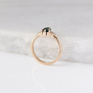 Pear Teal Green Sapphire Ring profile view with marble