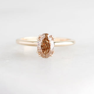 Yellow gold solitaire engagement ring with an oval champagne diamond, front view
