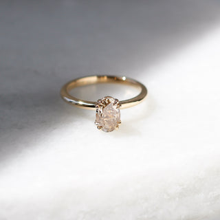 Yellow gold solitaire engagement ring with an oval champagne diamond, front view from above