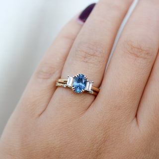 Oval Cut Blue Sapphire Ring with Diamond Gold Band on hand