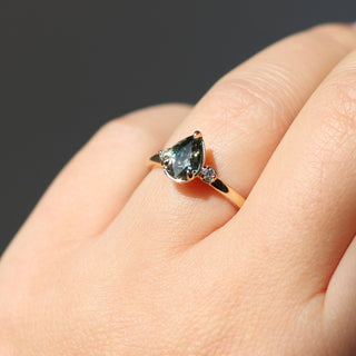 Lagoon Pear Green Sapphire Ring worn on hand in sunlight front view