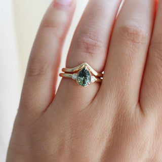 Lagoon Pear Green Sapphire Ring paired with wave gold band on hand front view