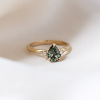Lagoon Pear Green Sapphire Ring quarter front view on cloth