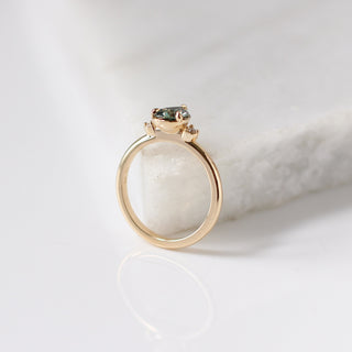 Lagoon Pear Green Sapphire Ring profile side view with marble