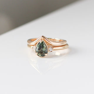 Lagoon Pear Green Sapphire Ring stacked with wave gold band quarter view 
