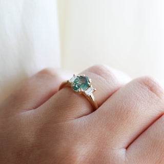 Trilogy Oval Green Sapphire Ring on hand detailed quarter side view in sunlight